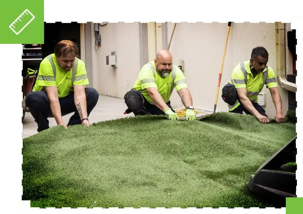 image of men installing synthetic turf